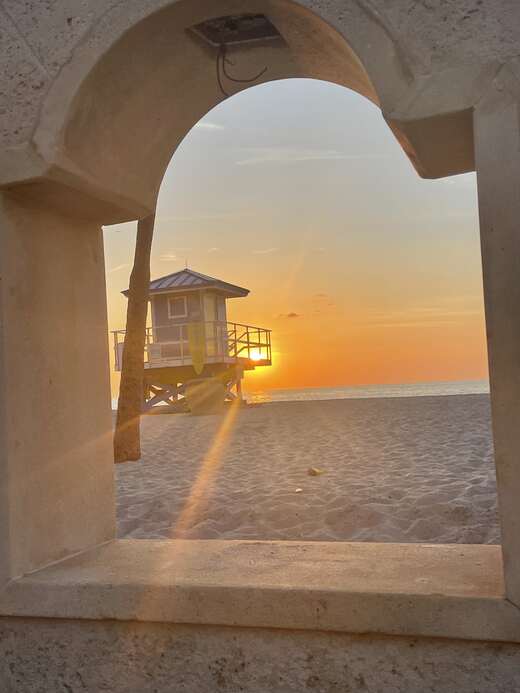 Sunrise framed by a Broadwalk arch