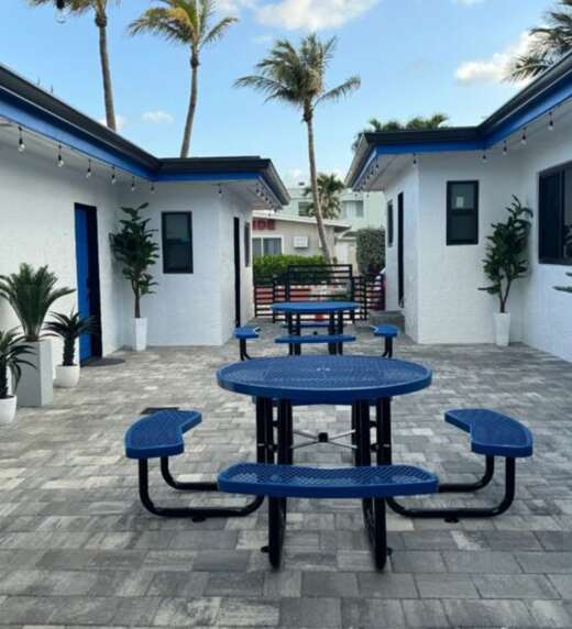 Courtyard with blue picnic tables and palms