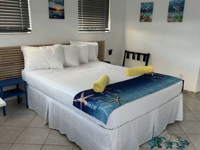 Queen studio with kitchenette, beach-themed bedding and a window seat