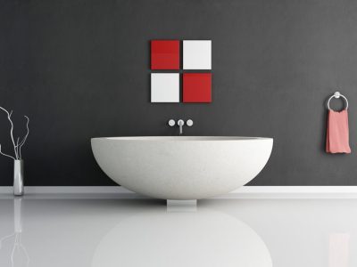 A white bath tub sitting in front of a wall.