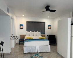 A bedroom with a bed, desk and chair.